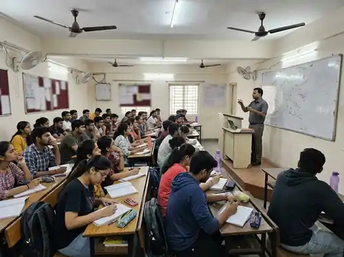 Educator explaining a concept in a coaching institute